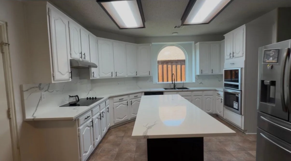 The same kitchen from the opposite corner, showing the full run of cabinetry